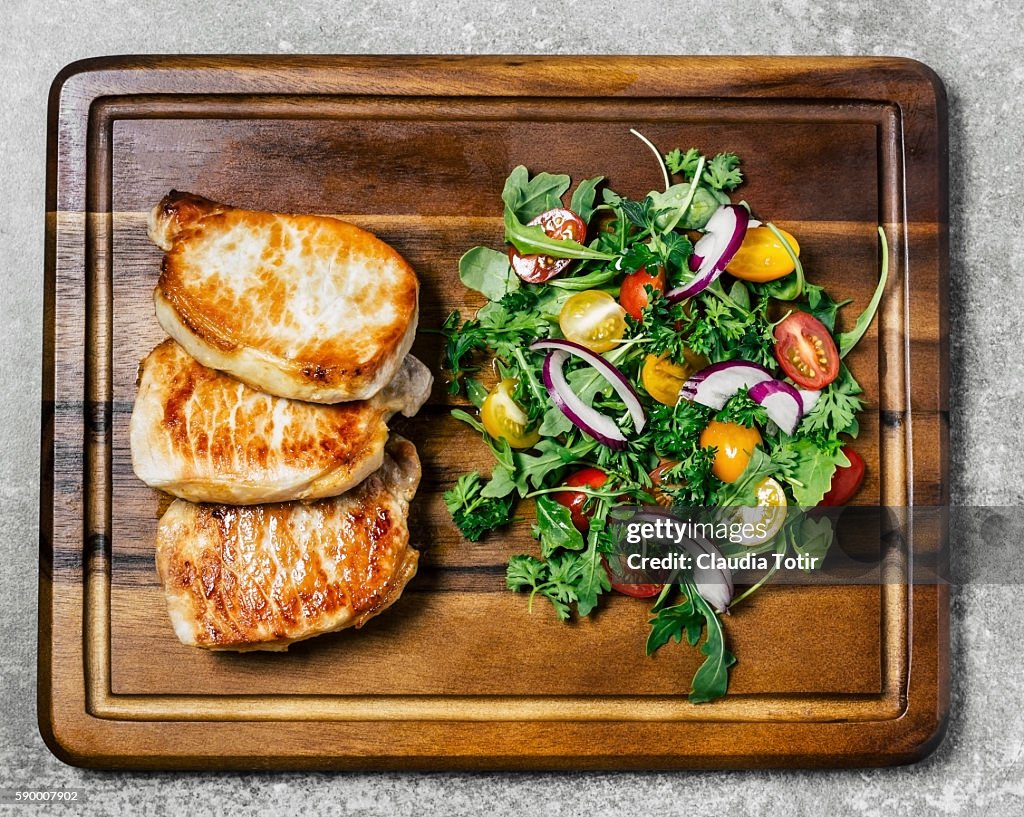 Roasted pork chops with salad