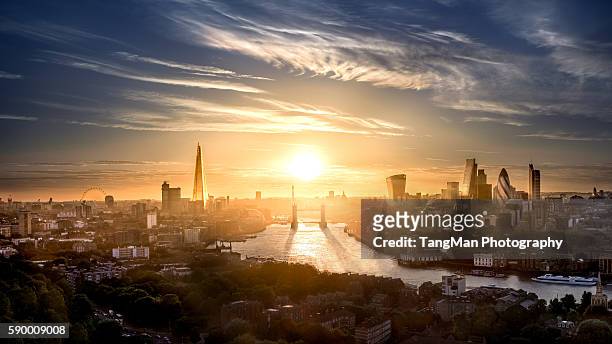 tower bridge and london the city along the thames - city of london aerial stock-fotos und bilder