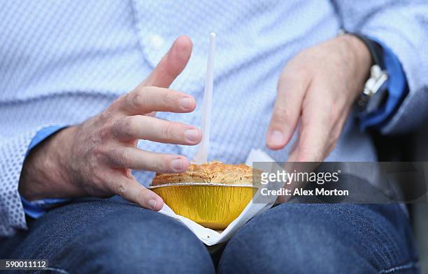 Fan eats a pie during the Premier League match between Hull City and Leicester City at KC Stadium on August 13, 2016 in Hull, England.