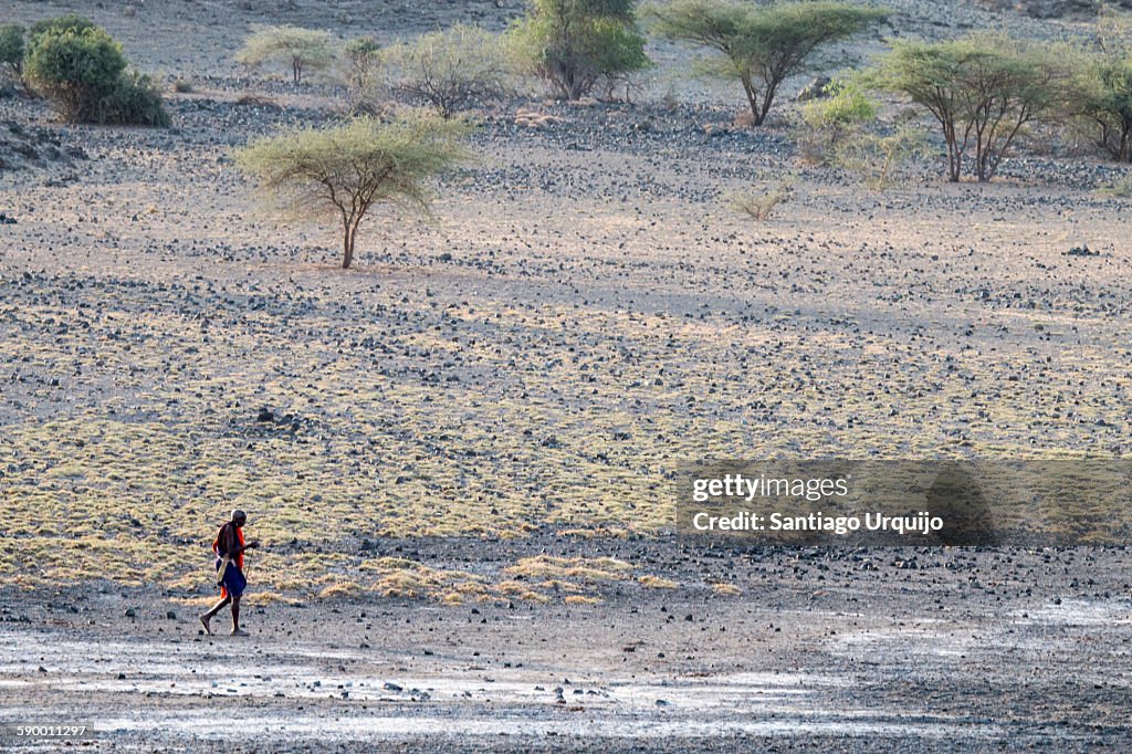 Masai man walking on Lake Natron