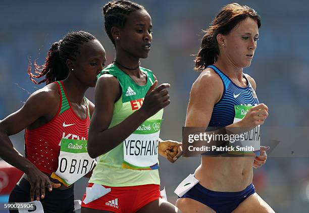 Shelby Houlihan of the United States competes with Ababel Yeshaneh of Ethiopia and Hellen Onsando Obiri of Kenya during the Women's 5000m Round 1 -...