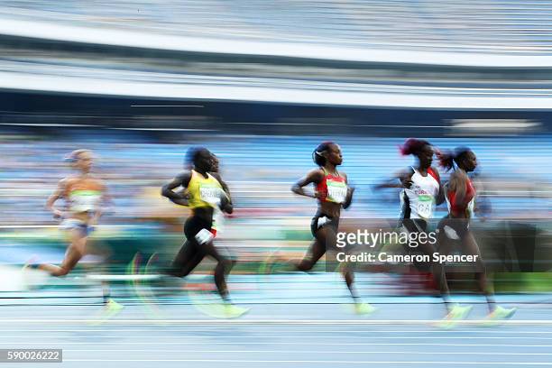 Yasemin Can of Turkey and Hellen Onsando Obiri of Kenya lead the pack during the Women's 5000m Round 1 - Heat 1 on Day 11 of the Rio 2016 Olympic...