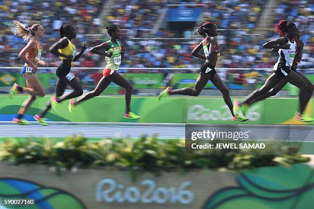 Turkey's Yasemin Can , Kenya's Mercy Cherono and Ethiopia's Ababel Yeshaneh compete in the Women's 5000m Round 1 during the athletics event at the...