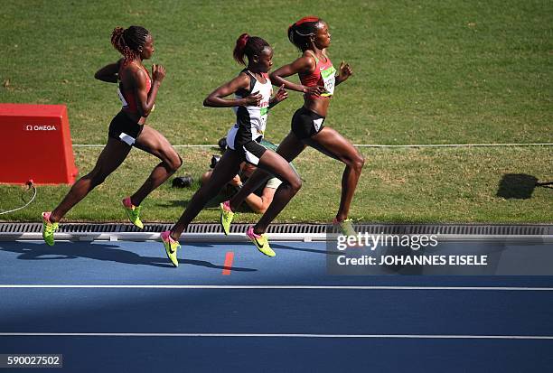 Kenya's Mercy Cherono and Turkey's Yasemin Can compete in the Women's 5000m Round 1 during the athletics event at the Rio 2016 Olympic Games at the...