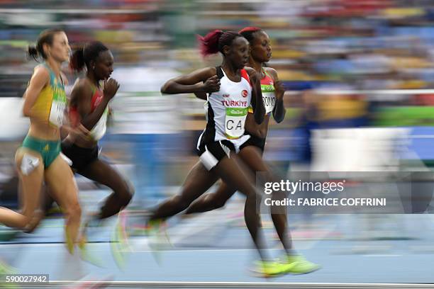 Turkey's Yasemin Can and Kenya's Mercy Cherono compete in the Women's 5000m Round 1 during the athletics event at the Rio 2016 Olympic Games at the...