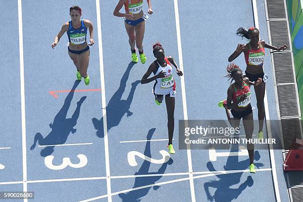 Kenya's Mercy Cherono, Kenya's Helen Obiri, Turkey's Yasemin Can and USA's Shelby Houlihan compete in the Women's 5000m Round 1 during the athletics...