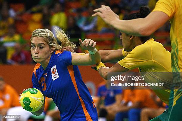 Netherlands' left back Estavana Polman vies with a Brazilian player during the women's quarterfinal handball match Brazil vs Netherlands for the Rio...
