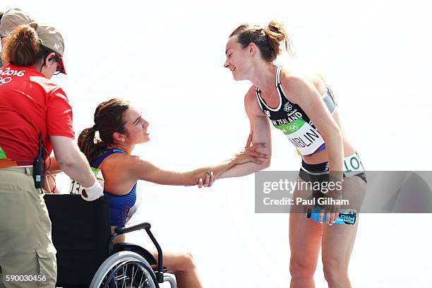 Abbey D'Agostino of the United States talks with Nikki Hamblin of New Zealand after the Women's 5000m Round 1 - Heat 2 on Day 11 of the Rio 2016...