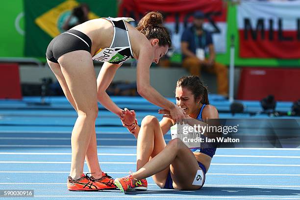 Abbey D'Agostino of the United States is assisted by Nikki Hamblin of New Zealand after a collision during the Women's 5000m Round 1 - Heat 2 on Day...