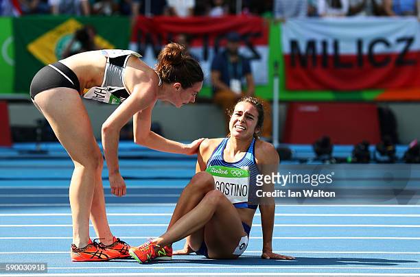 Abbey D'Agostino of the United States is assisted by Nikki Hamblin of New Zealand after a collision during the Women's 5000m Round 1 - Heat 2 on Day...