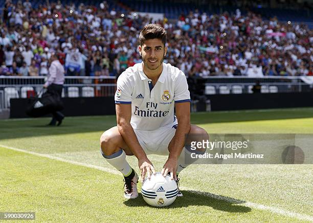 Marco Asensio of Real Madrid poses during his official presentation at Estadio Santiago Bernabeu on August 16, 2016 in Madrid, Spain.