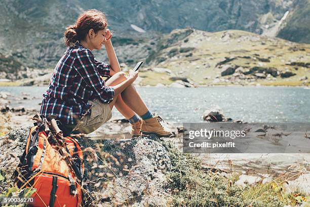 high in the mountain and texting - remote location cell phone stock pictures, royalty-free photos & images