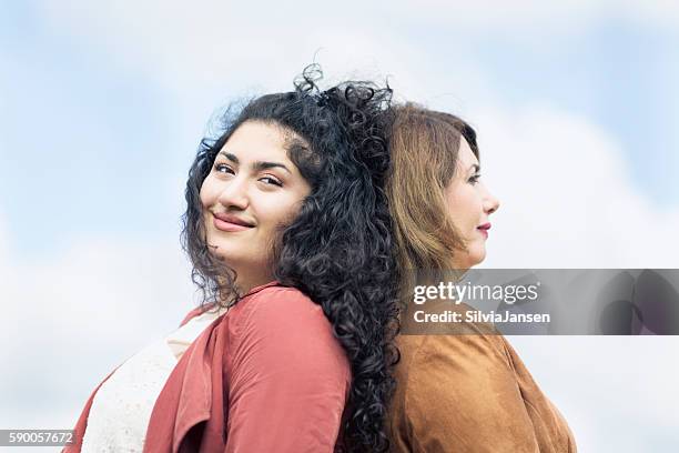 mature mother and adult daughter together back to back - chesty love stock pictures, royalty-free photos & images