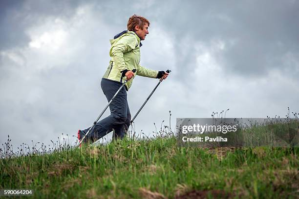 mature woman nordic walking on plateau, slovenia, europe - scandinavian imagens e fotografias de stock