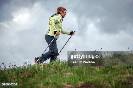 Mature Woman Nordic Walking on Plateau, Slovenia, Europe Mature Woman Nordic Walking on Plateau, Slovenia, Europe