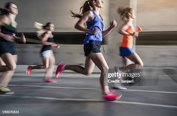 group of young woman running outdoors - marathon stock pictures, royalty-free photos & images