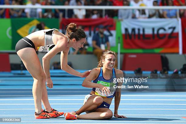 Abbey D'Agostino of the United States is assisted by Nikki Hamblin of New Zealand after a collision during the Women's 5000m Round 1 - Heat 2 on Day...