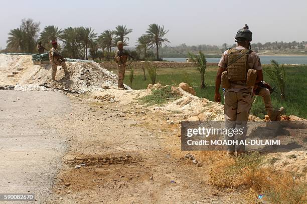 Members of the Iraqi government forces keep watch on August 15, 2016 in Dulab, in the Haditha area, west of Ramadi, the capital of Iraq's Anbar...