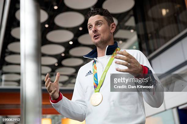 Great Britain's Justin Rose speaks to reporters with his Gold Medal after arriving on a British Airways flight from Rio de Janeiro in Brazil to...