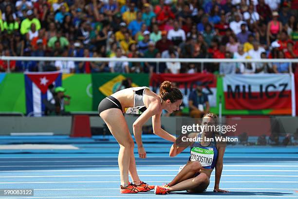 Abbey D'Agostino of the United States is assisted by Nikki Hamblin of New Zealand after a collision during the Women's 5000m Round 1 - Heat 2 on Day...