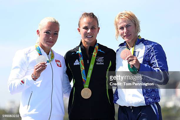 Silver medalist Marta Walczykiewicz of Poland, gold medalist Lisa Carrington of New Zealand and bronze medalist Inna Osipenko-Rodomska of Azerbaijan...