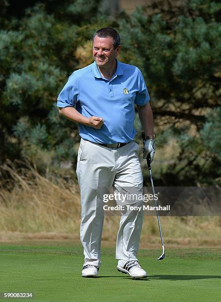 Nigel Perry of Abbeydale Golf Club celebrates sinking his putt on the 18th green during the PGA Pro-Captain Midland Qualifier at Enville Golf Club on...