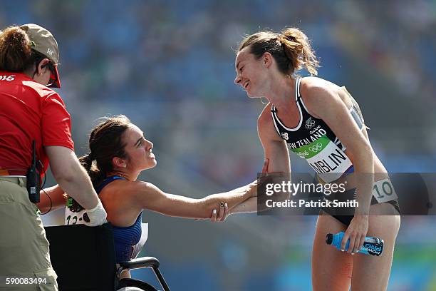 Abbey D'Agostino of the United States talks with Nikki Hamblin of New Zealand after the Women's 5000m Round 1 - Heat 2 on Day 11 of the Rio 2016...