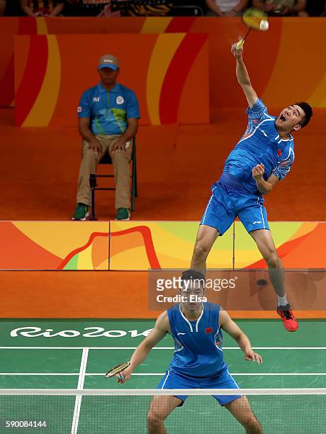 Biao Chai and Wei Hong of China return a shot to Shem V Goh and Wee Kiong Tan of Malaysia during the Men's Doubles Semifinal on Day 11 of the Rio...
