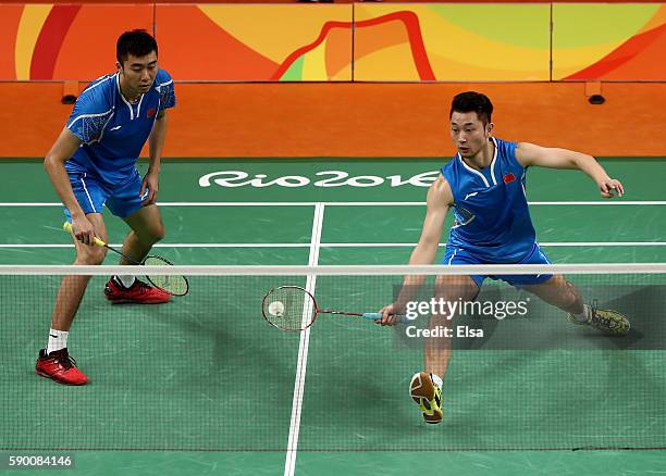 Biao Chai and Wei Hong of China return a shot to Shem V Goh and Wee Kiong Tan of Malaysia during the Men's Doubles Semifinal on Day 11 of the Rio...