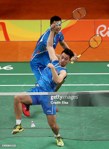 Biao Chai and Wei Hong of China return a shot to Shem V Goh and Wee Kiong Tan of Malaysia during the Men's Doubles Semifinal on Day 11 of the Rio...