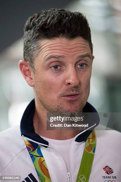 Great Britain's Justin Rose speaks to reporters with his Gold Medal after arriving on a British Airways flight from Rio de Janeiro in Brazil to...