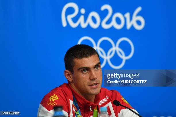 Russia's Evgeny Tishchenko speaks to the press after receiving his medal at the Rio 2016 Olympic Games at the Riocentro - Pavilion 6 in Rio de...