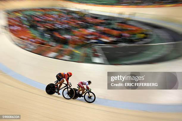 Netherlands' Elis Ligtlee races Russia's Anastasiia Voinova during the Women's sprint quarter-finals track cycling event at the Velodrome during the...