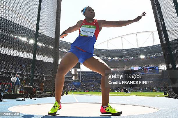 Cuba's Denia Caballero competes in the Women's Discus Throw Final during the athletics competition at the Rio 2016 Olympic Games at the Olympic...