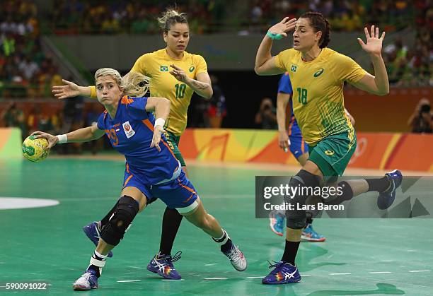 Estavana Polman of Netherlands is challenged by Jessica Quintino of Brazil and Eduarda Taleska of Brazil during the Womens Quarterfinal match between...
