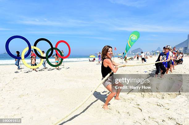 Access Hollywood host, Kit Hoover in a tug of war against United States Olympians on the Today show set on Copacabana Beach on August 16, 2016 in Rio...