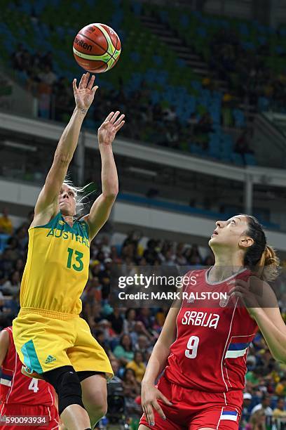 Australia's shooting guard Erin Phillips 9L) takes a shot over Serbia's power forward Jelena Milovanovic during a Women's quarterfinal basketball...