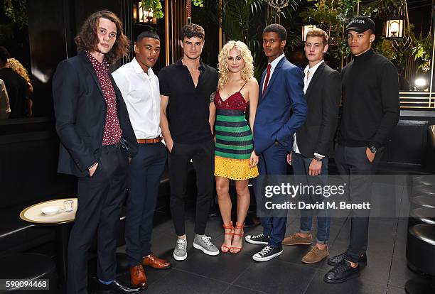 Pixie Lott poses with models Liam Gardner, Kemar Cummins, Christian Arno Williams, O'Shea Robertson, Rob Knighton and Omari Dixon at the launch of...