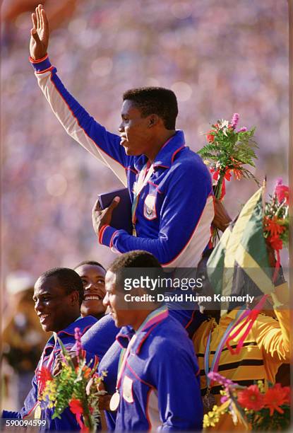 Carl Lewis waves to the crowed while being carried by his teammates and other athletes after team USA won the gold medal for the Men's 4x100m Relay...