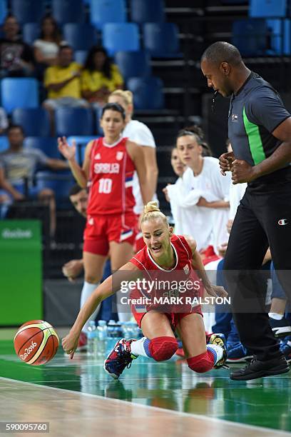 Serbia's point guard Milica Dabovic reaches out for the ball next to France's referee Eddie Viator during a Women's quarterfinal basketball match...