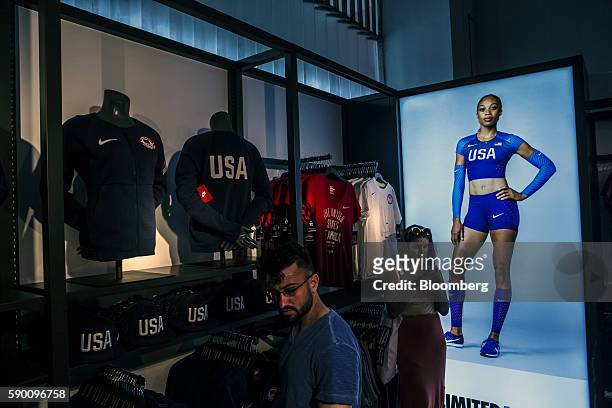An advertisement with U.S. Olympic track and field athlete Allyson Felix is displayed next to Nike Inc. Apparel for sale at the Team USA Shop in the...