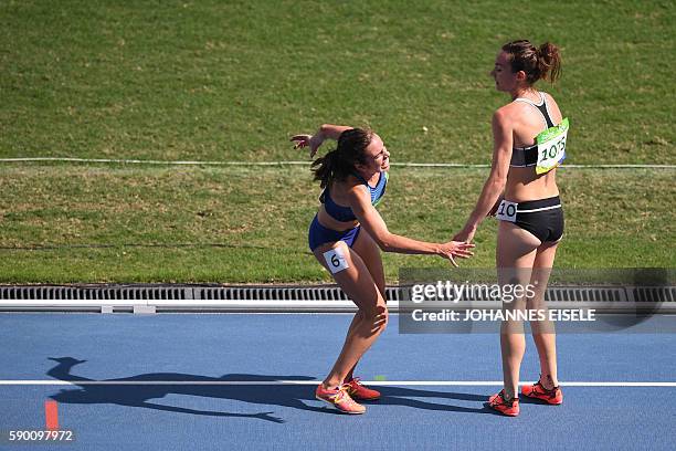 New Zealand's Nikki Hamblin helps USA's Abbey D'agostino after she was injured in the Women's 5000m Round 1 during the athletics event at the Rio...