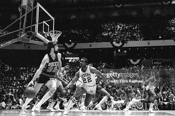 Brian Winters of the Milwaukee Bucks dribbles the ball up court while guarded by Andrew Toney of the Philadelphia 76ers at The Spectrum in...