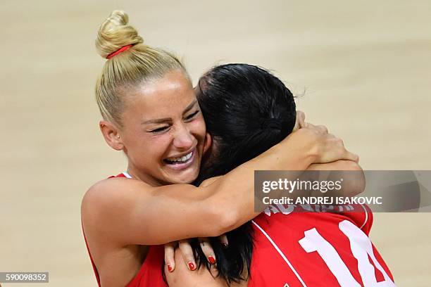 Serbia's shooting guard Ana Dabovic embraces Serbia's point guard Milica Dabovic after defeating Australia during a Women's quarterfinal basketball...