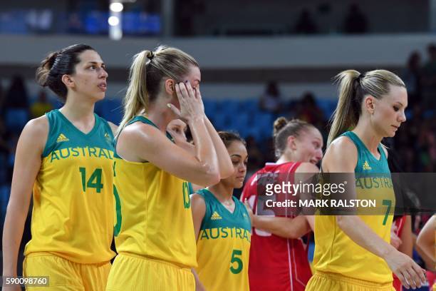 Australia's centre Marianna Tolo, Australia's small forward Rachel Jarry, Serbia's forward Sonja Petrovic and Australia's forward Penny Taylor react...