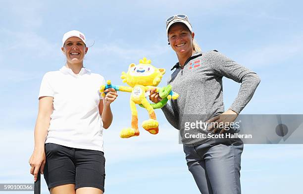 Marianne Skarpnord and Suzann Pettersen of Norway pose together during a practice round prior to the start of the women's golf during Day 11 of the...