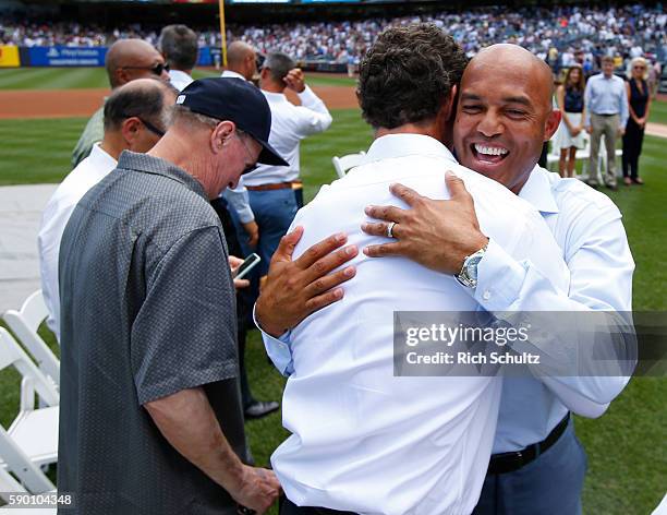 Paul O'Neil and Mariano Rivera hug after a monument plaque ceremony honoring Rivera before a game between the Tampa Bay Rays and the New York Yankees...