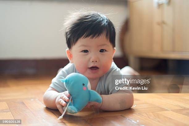 baby boy playing toy whale - boy floor stockfoto's en -beelden