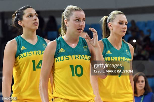 Australia's centre Marianna Tolo, Australia's small forward Rachel Jarry and Australia's forward Penny Taylor react after losing to Serbia during a...