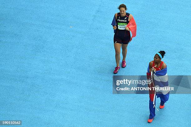 France's Melina Robert-Michon and Cuba's Denia Caballero celebrate after finishing respectively second and third of the Women's Discus Throw Final...